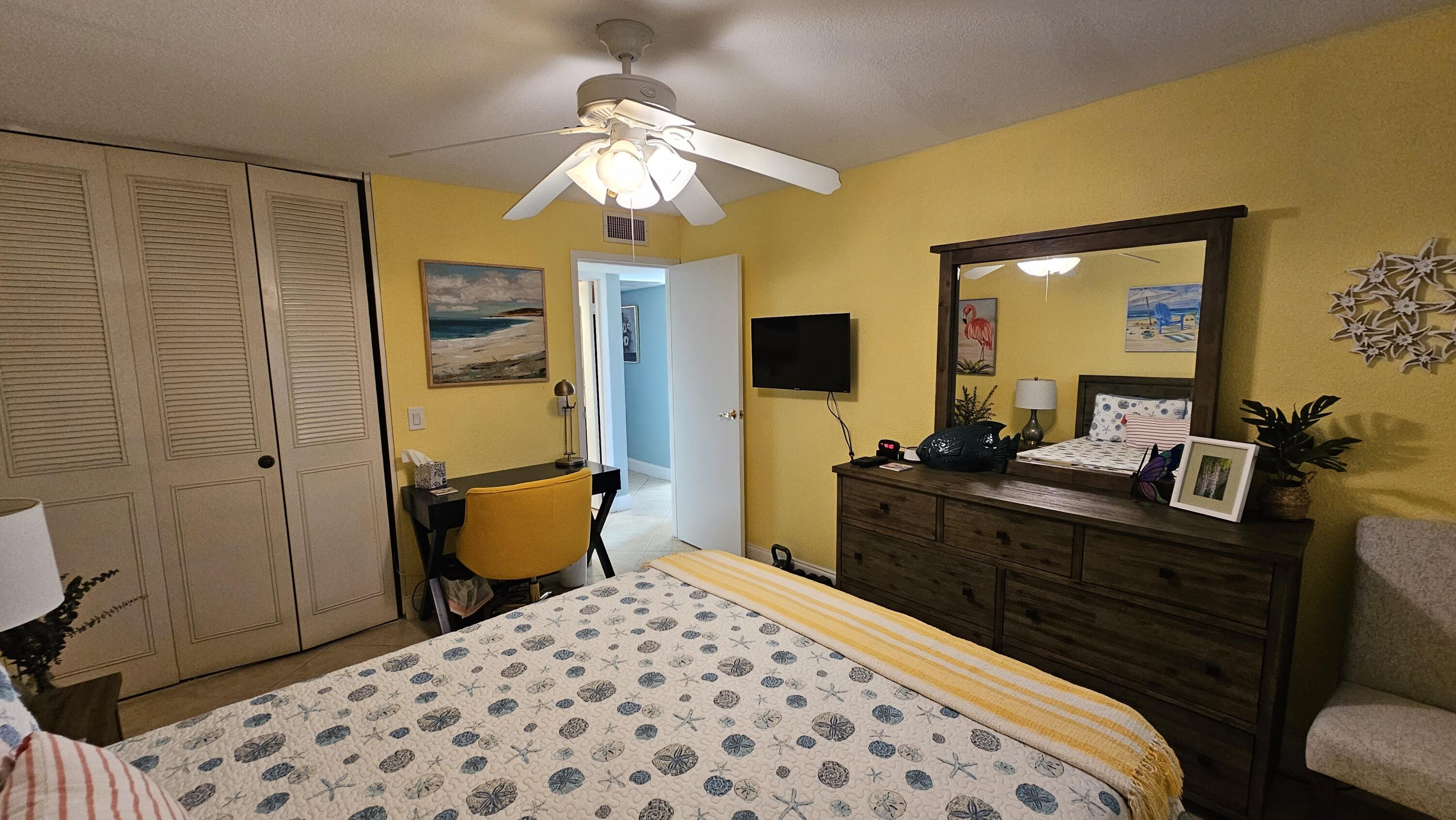 256 Seville K Delray Beach, FL 33446 - Photo 10 of 45 a bedroom with a bed and a chandelier