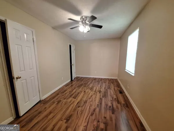 wooden floor in an empty room with a window