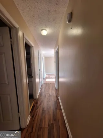 a view of hallway with wooden floor