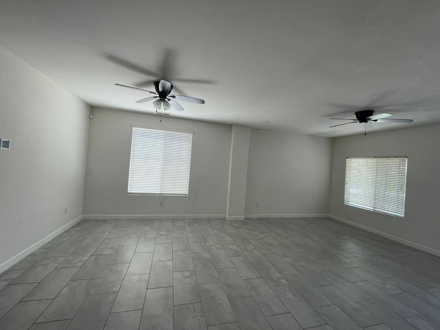 3123 Burgan Avenue Clovis, CA 93611 - Photo 11 of 26 an empty room with windows and ceiling fan