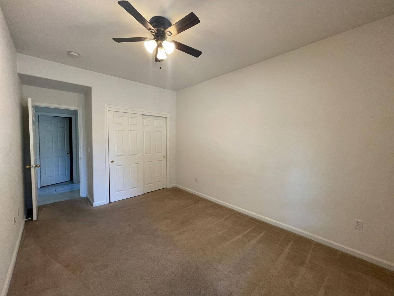 3123 Burgan Avenue Clovis, CA 93611 - Photo 13 of 26 an empty room with a fan & a ceiling fan