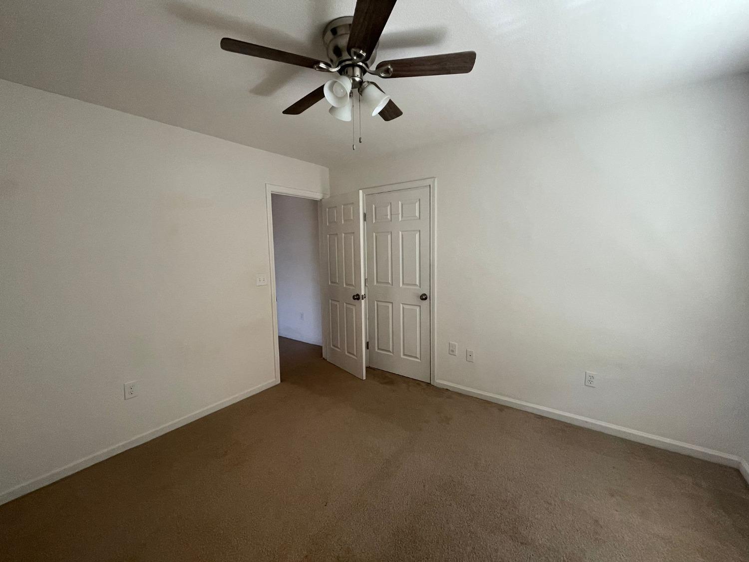 3123 Burgan Avenue Clovis, CA 93611 - Photo 16 of 26 an empty room with a ceiling fan and a window