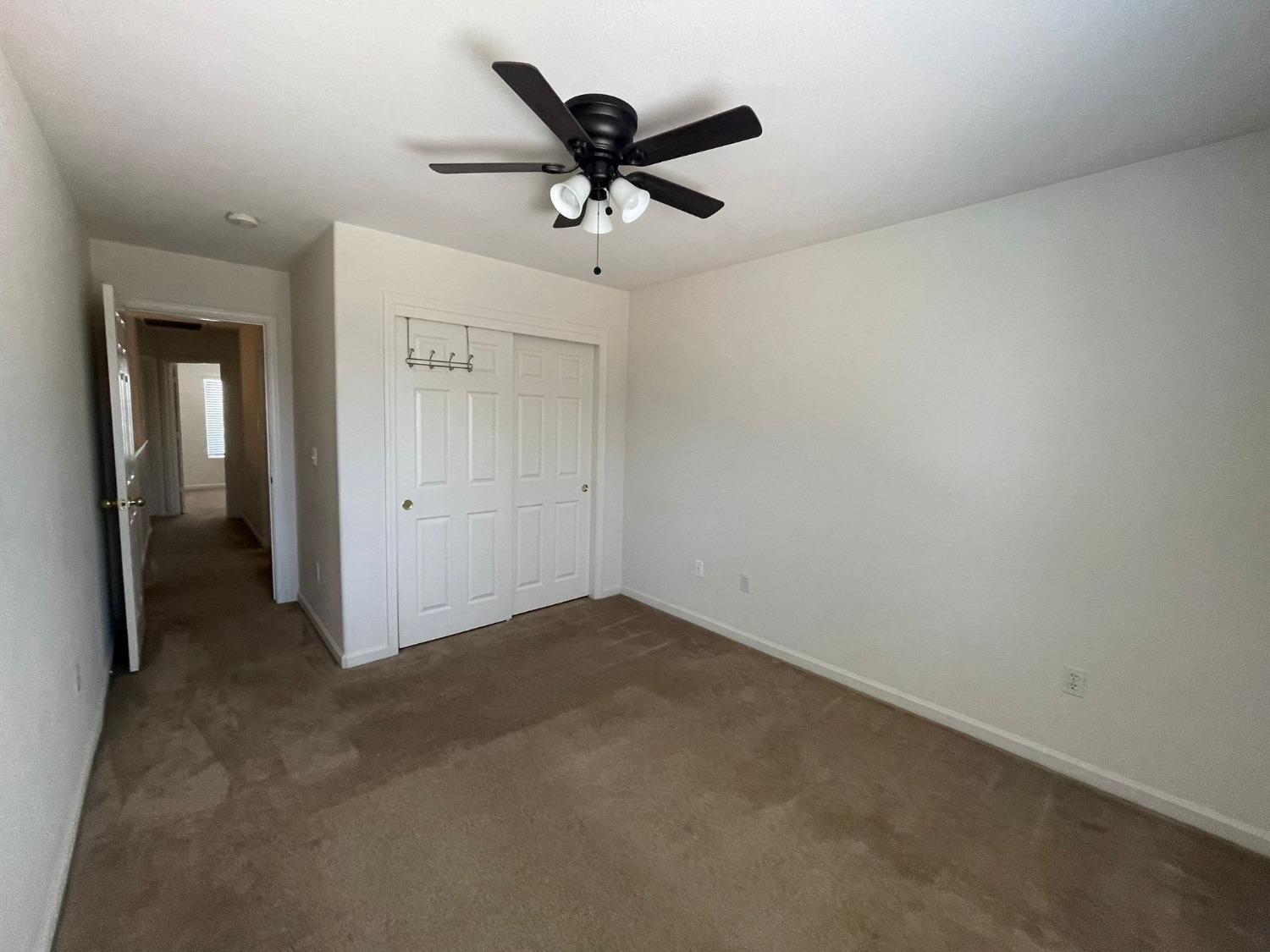 3123 Burgan Avenue Clovis, CA 93611 - Photo 17 of 26 an empty room with closet and ceiling fan