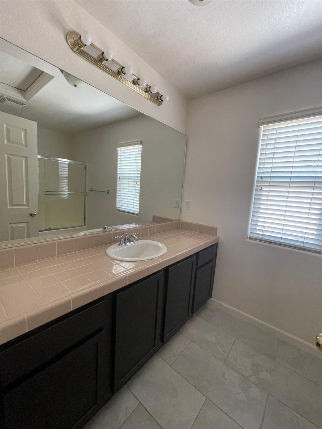 3123 Burgan Avenue Clovis, CA 93611 - Photo 18 of 26 a bathroom with a sink and a mirror