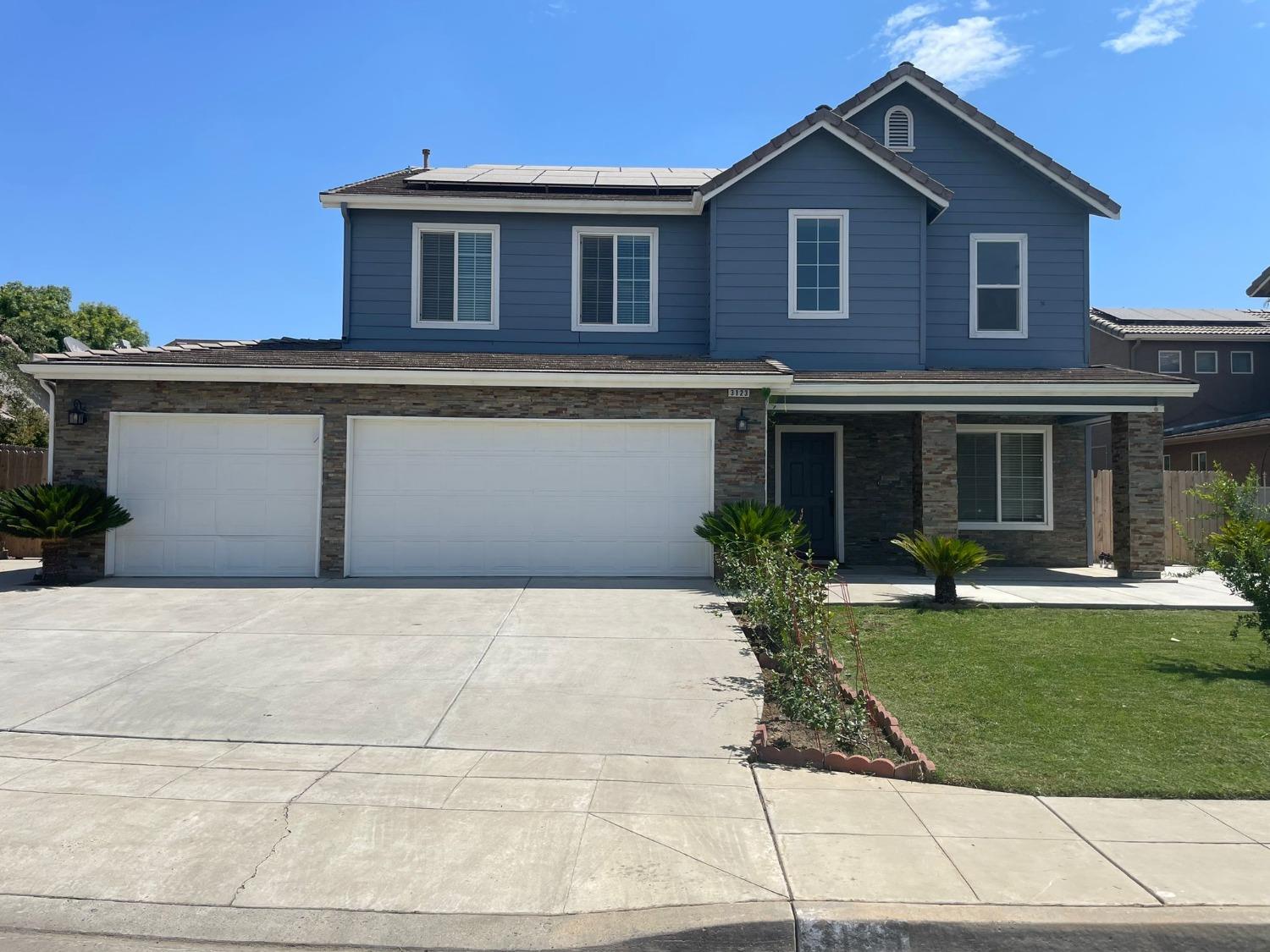 3123 Burgan Avenue Clovis, CA 93611 - Photo 2 of 26 a front view of a house with a yard