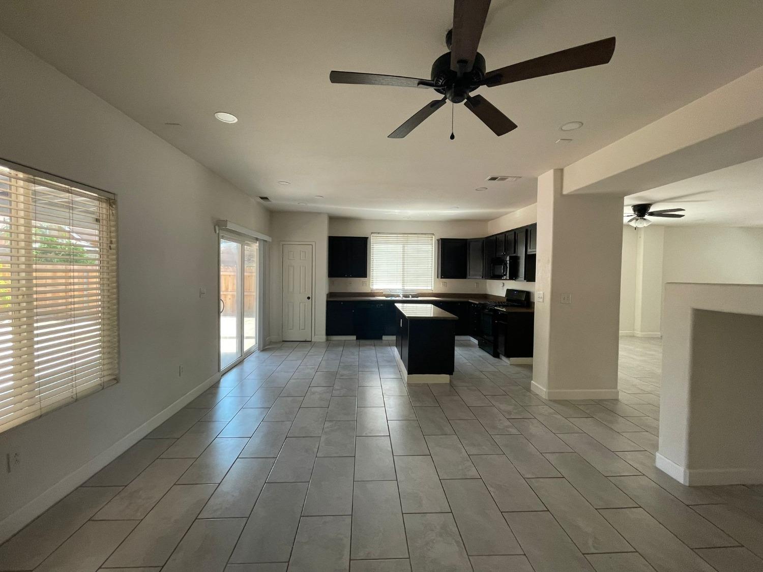 3123 Burgan Avenue Clovis, CA 93611 - Photo 6 of 26 a large kitchen with kitchen island a sink stainless steel appliances and cabinets