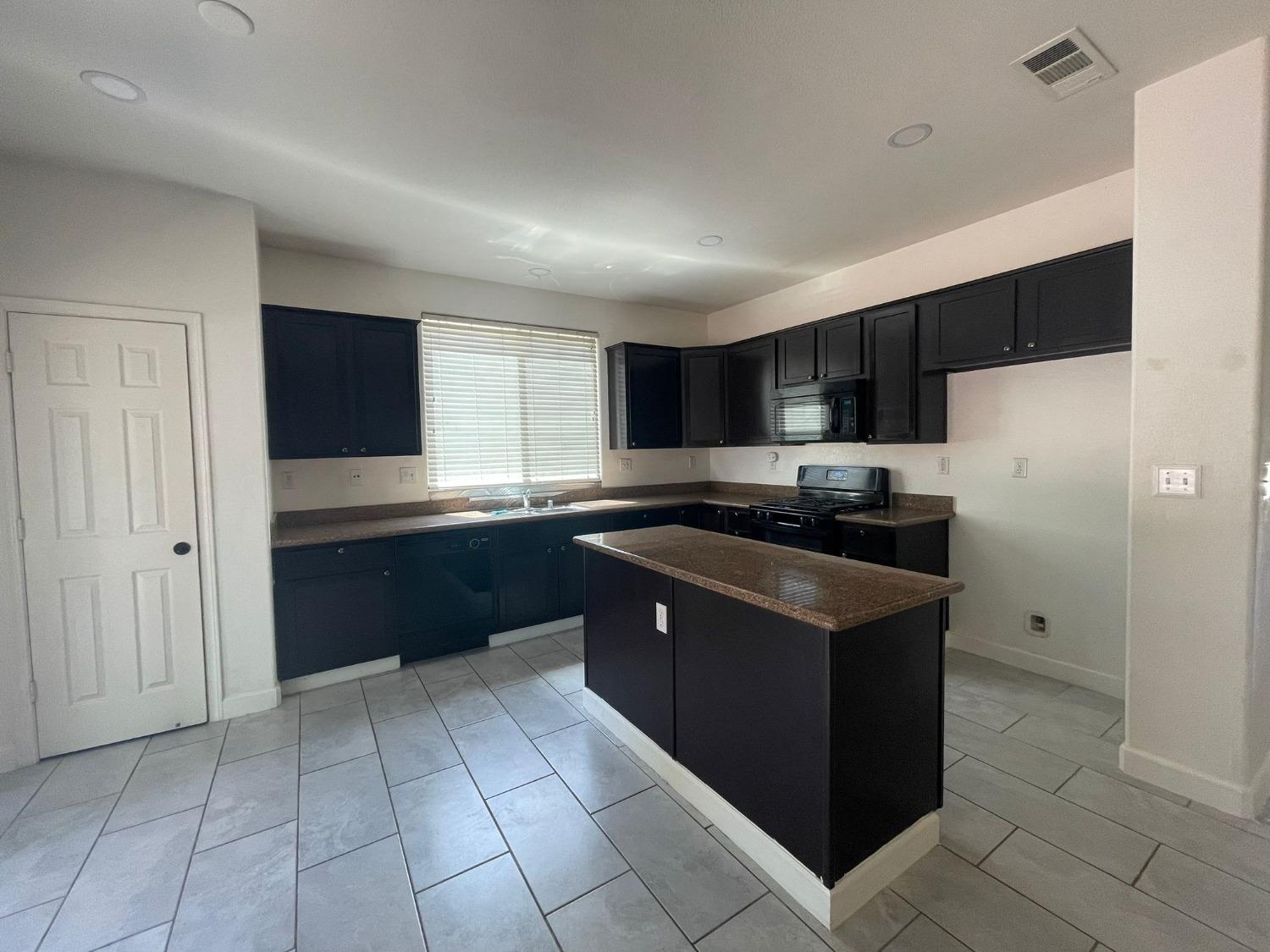 3123 Burgan Avenue Clovis, CA 93611 - Photo 7 of 26 a kitchen with stainless steel appliances granite countertop a refrigerator and a sink