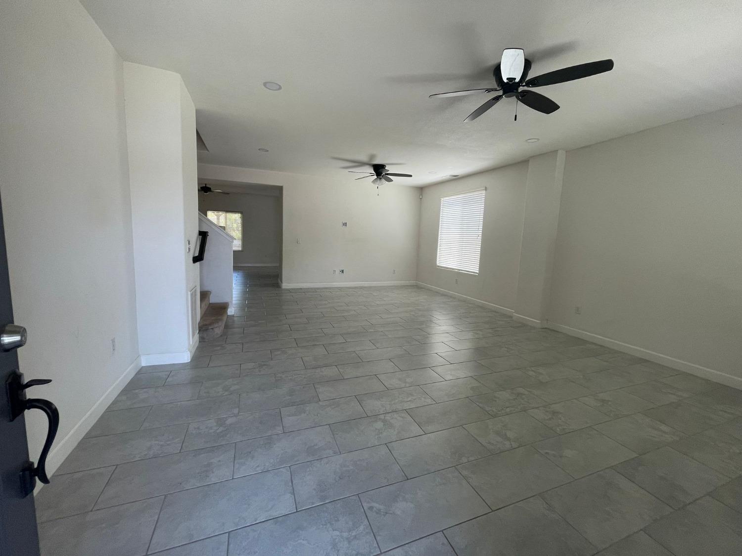 3123 Burgan Avenue Clovis, CA 93611 - Photo 9 of 26 a view of a livingroom with a ceiling fan and window