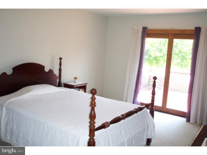 1249 Mink Road Perkasie, PA 18944 - Photo 12 of 18 a bedroom with a bed and a large window