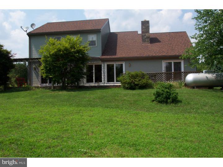 1249 Mink Road Perkasie, PA 18944 - Photo 4 of 18 a front view of a house with a yard and trees