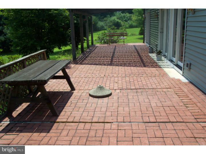 1249 Mink Road Perkasie, PA 18944 - Photo 5 of 18 a view of a patio with table and chairs with wooden floor and fence