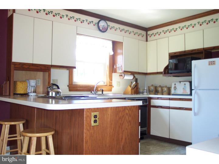 1249 Mink Road Perkasie, PA 18944 - Photo 10 of 18 a kitchen with kitchen island a sink a stove a refrigerator and cabinets