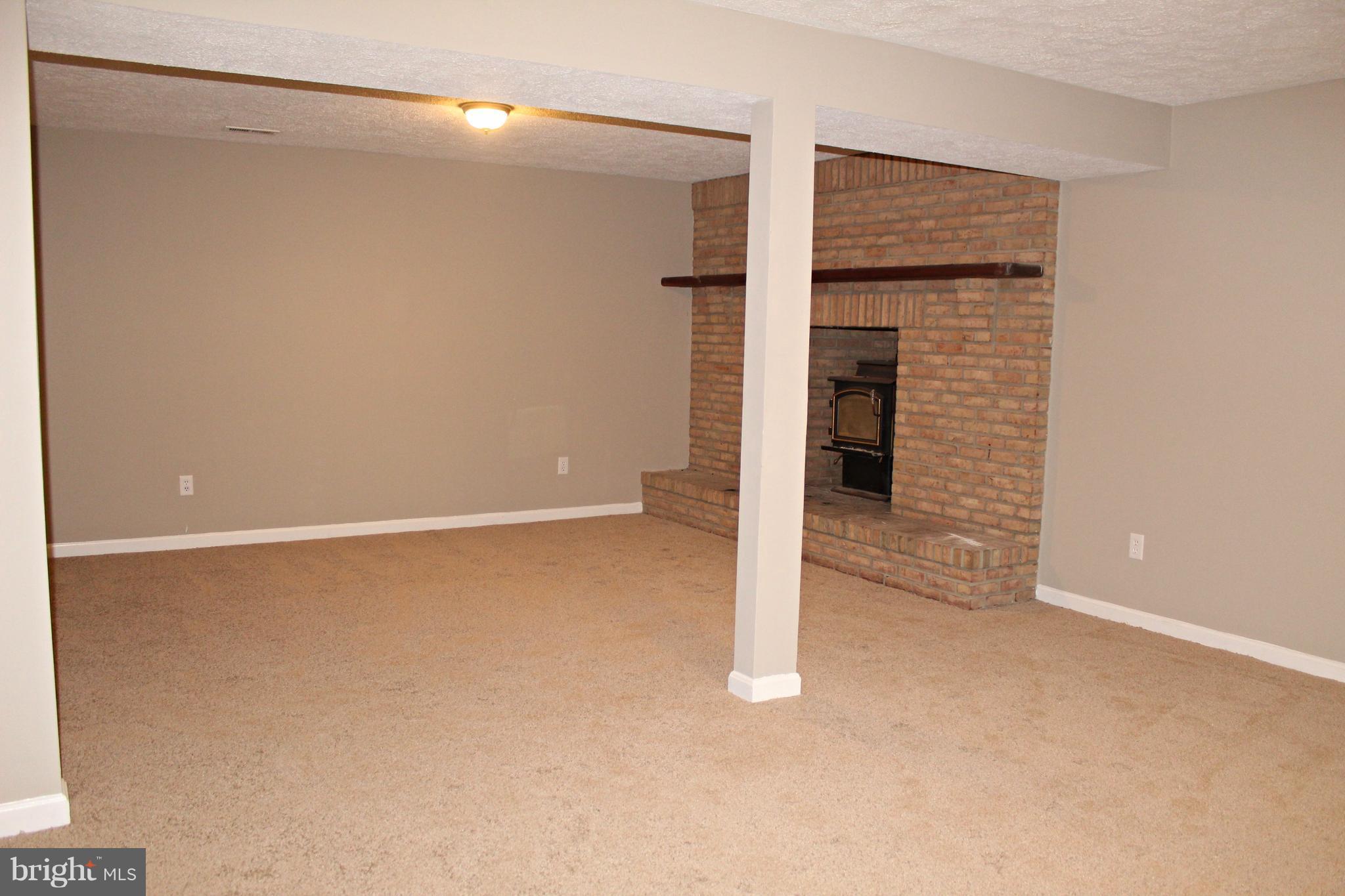 668 San Gabriel Road Lusby, MD 20657 - Photo 21 of 28 Finished Walkout Basement with Fireplace!