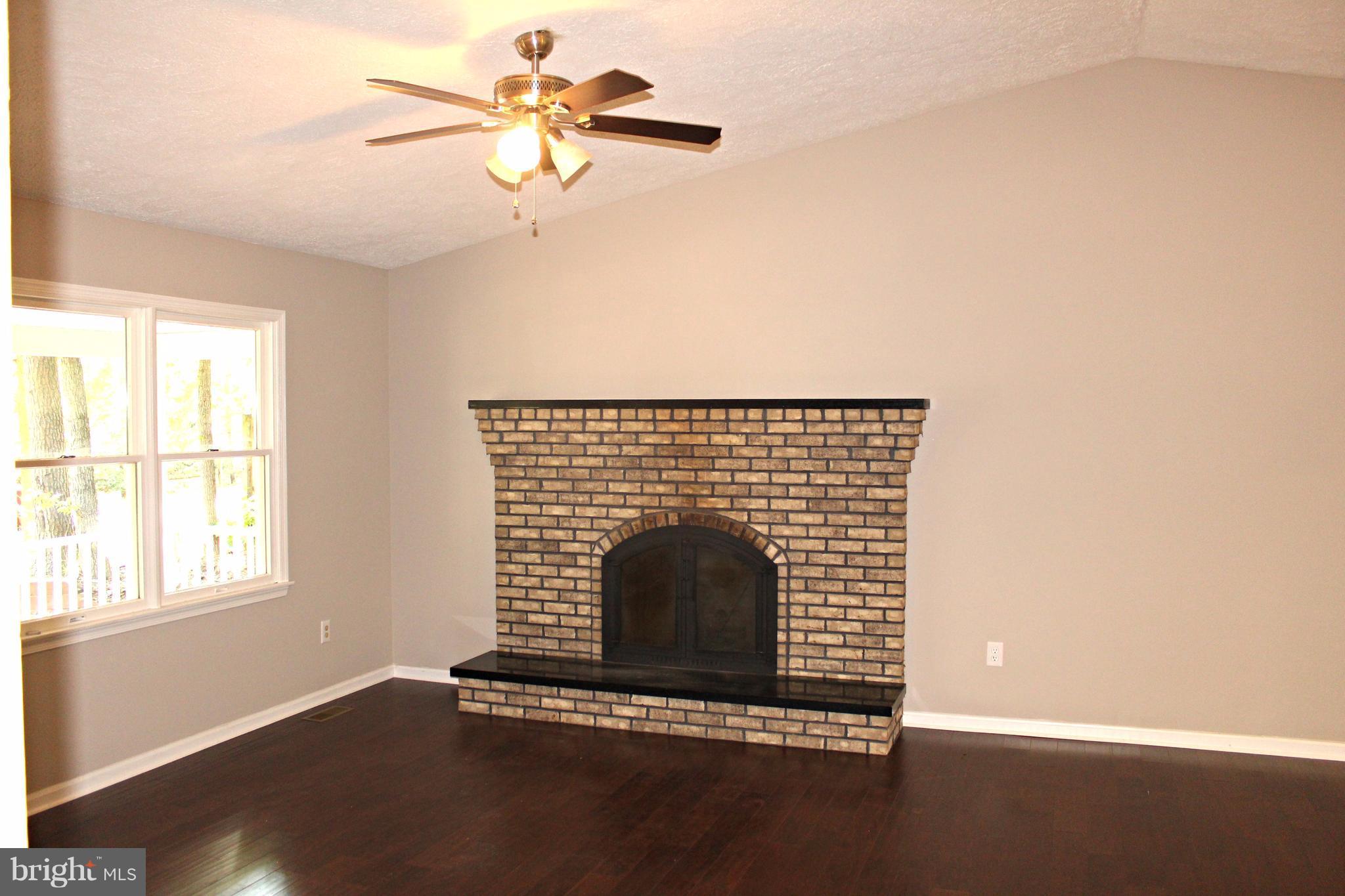 668 San Gabriel Road Lusby, MD 20657 - Photo 7 of 28 Fireplace and Hardwood Flooring in Living Room!