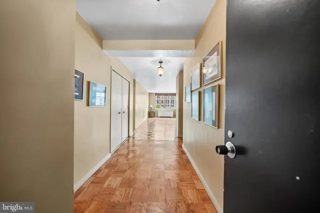 a view of a hallway with wooden floor and staircase