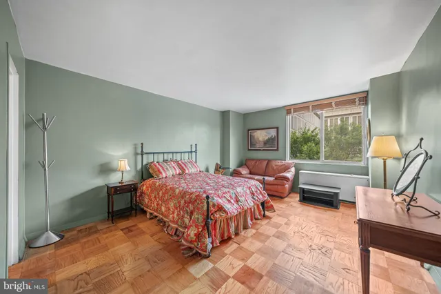 a bedroom with a bed and a couch