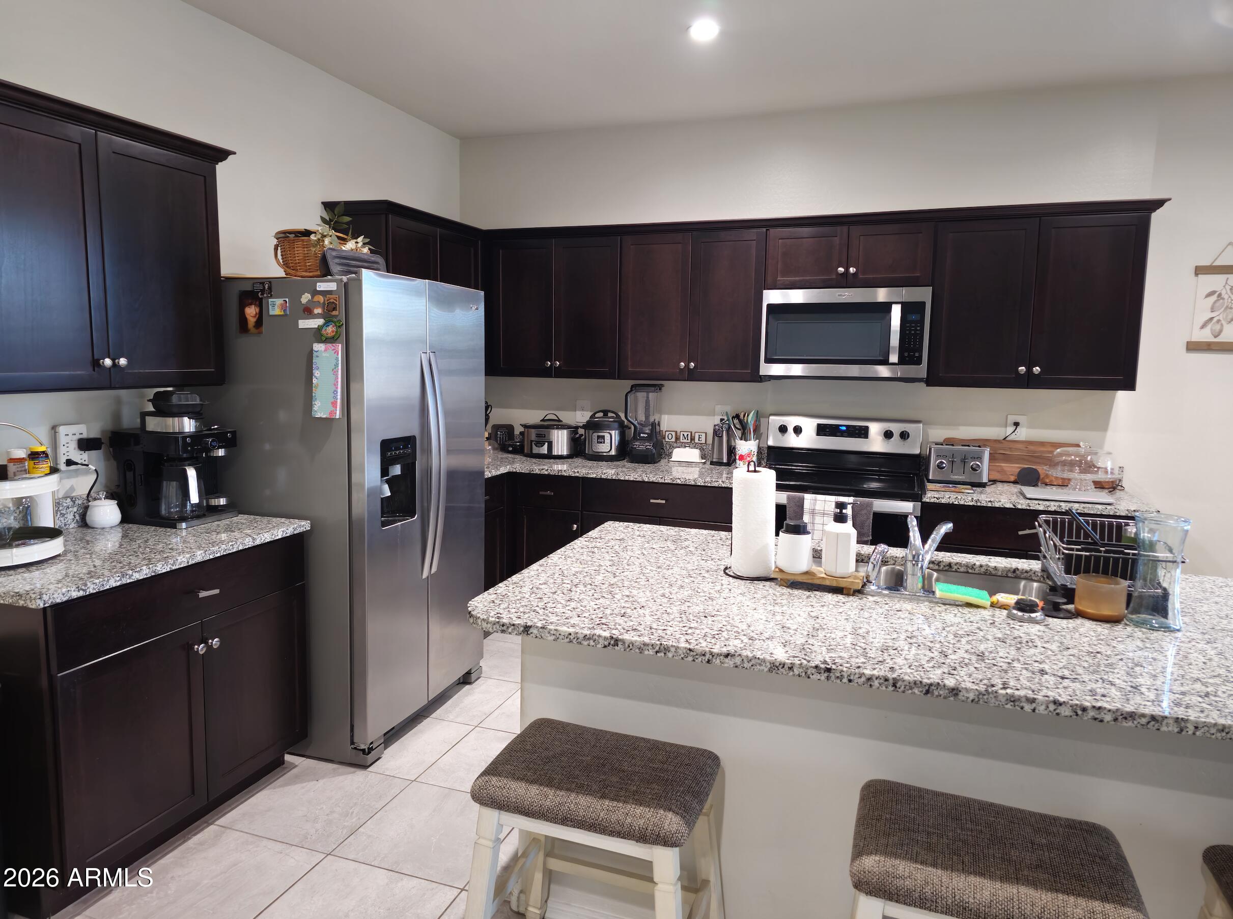 9434 Cotton Road Florence, AZ 85132 - Photo 5 of 25 a kitchen with refrigerator and microwave