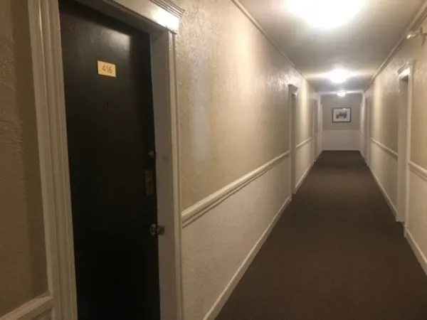 a front view of a residential apartment building with a yard