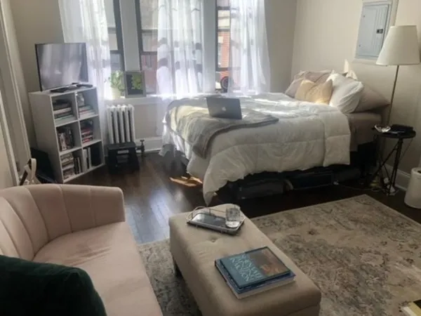 a living room with furniture fireplace and a large window