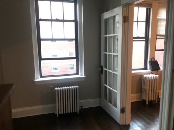 66 Queensberry Street, Unit 416 Boston, MA 02215 - Photo 6 of 18 a view of an empty room with wooden floor and a window