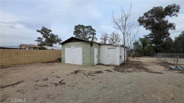 a dirt road with trees in front of it