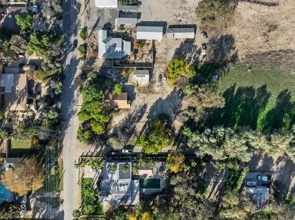 a view of a yard with wooden fence