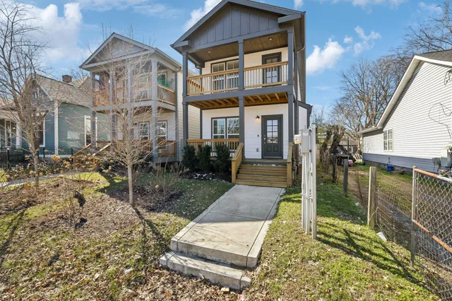 a living room with furniture a fireplace and a large window