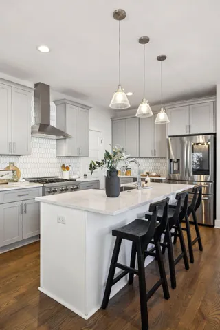 an empty room with wooden floor closet and windows