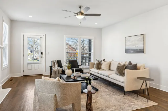 a living room with furniture a fireplace and window