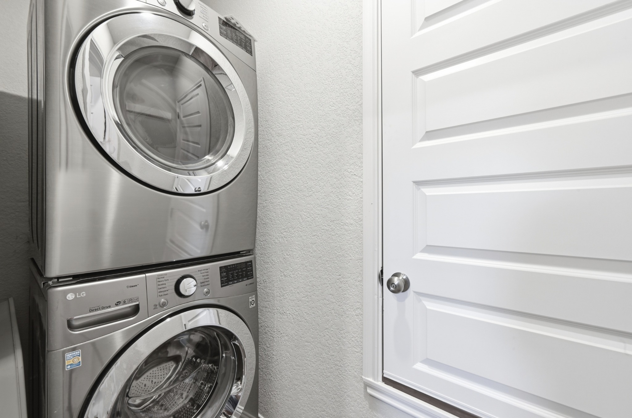 8201 Frida Bend Austin, TX 78744 - Photo 26 of 29 A convenient stacked laundry pair with modern finishes optimizes space.