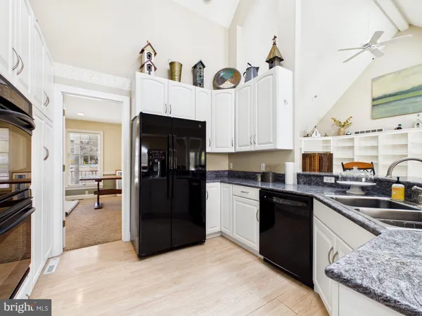 a bathroom with a double vanity sink and mirror with toilet