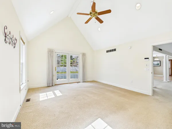 a view of a livingroom with workspace and a window