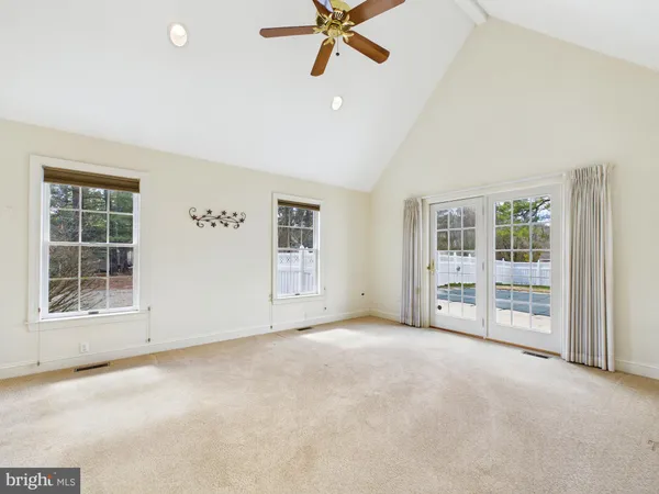 a living room with furniture pool table and windows