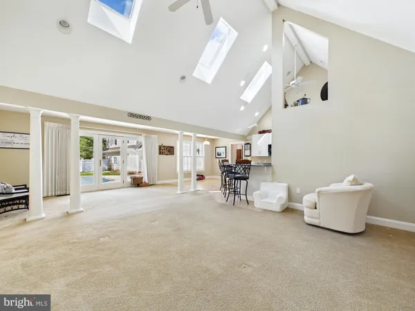 a living room with furniture a dining table and chairs with wooden floor