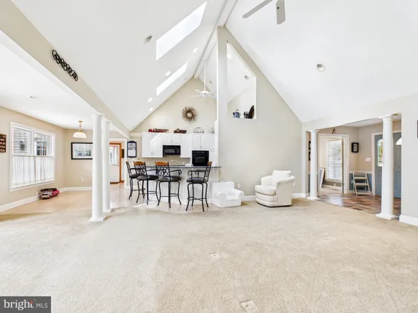 a kitchen with stainless steel appliances kitchen island granite countertop a refrigerator and a sink