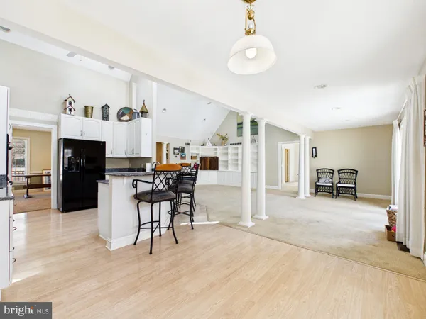 an empty room with windows and ceiling fan