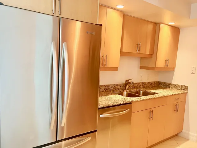 a kitchen with stainless steel appliances granite countertop a stove and a microwave