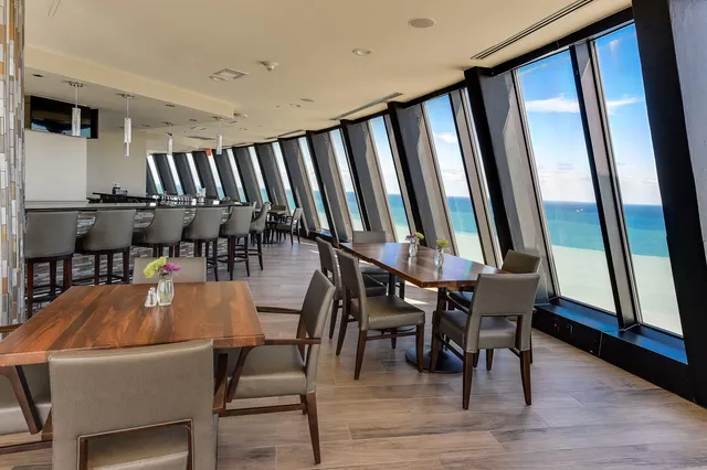 a view of a house with swimming pool and sitting area