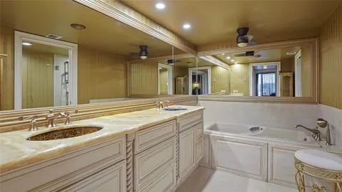 a bathroom with a sink double vanity granite and a mirror