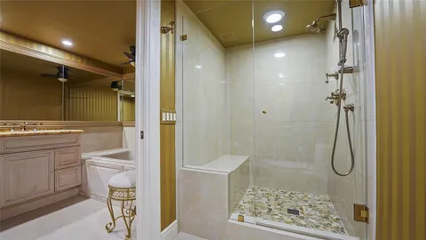 a bathroom with a shower and a sink