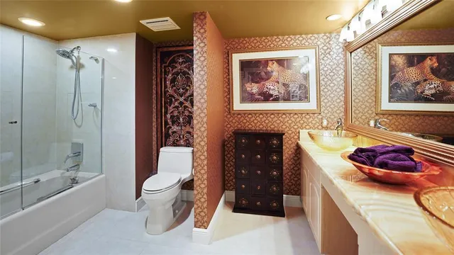 a spacious bathroom with a granite countertop sink a toilet and bathtub