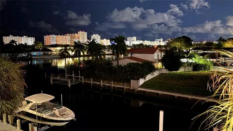 a view of a balcony with chairs and potted plants