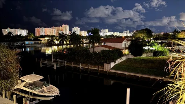 a view of a balcony with chairs and potted plants