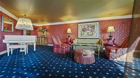 a living room with furniture a rug and a lamp