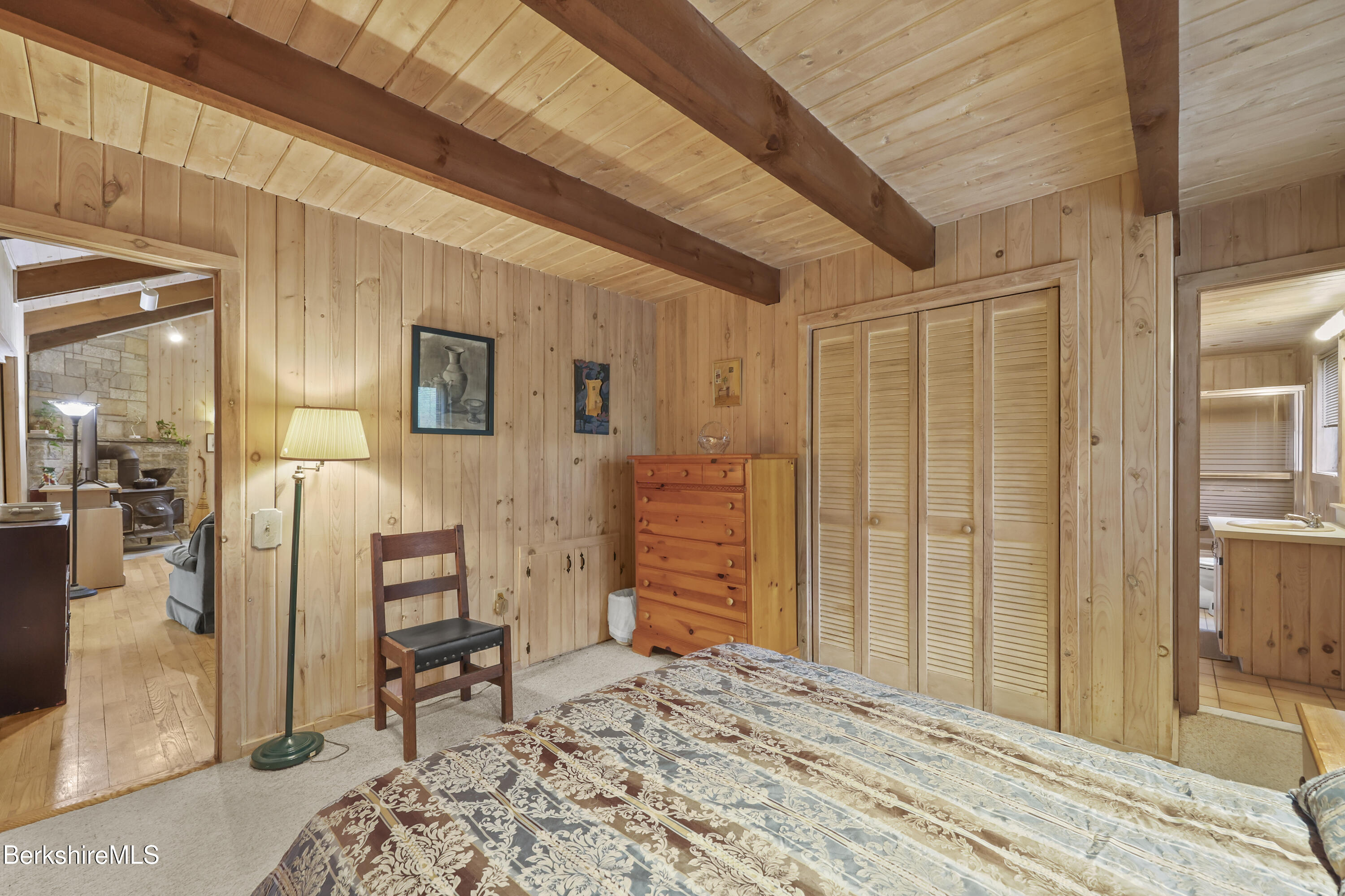422 Bonny Rigg Hill Road Becket, MA 01223 - Photo 25 of 60 a bedroom with a bed and a chair