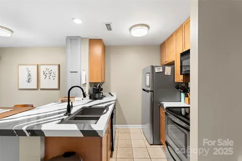a kitchen with a sink cabinets and appliances