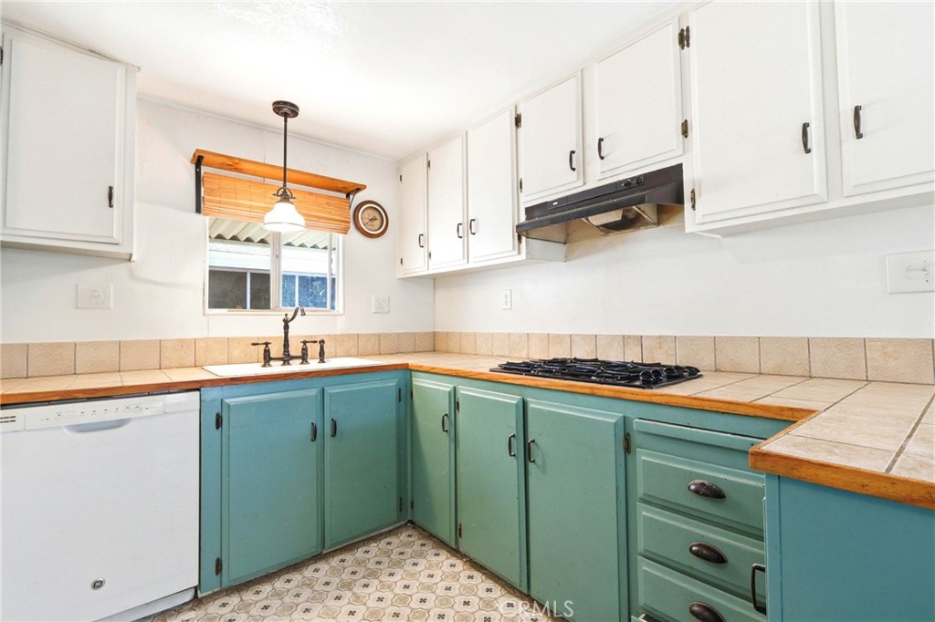 9391 California Avenue, Unit 35 Riverside, CA 92503 - Photo 13 of 32 a kitchen with stainless steel appliances granite countertop a sink stove and cabinets