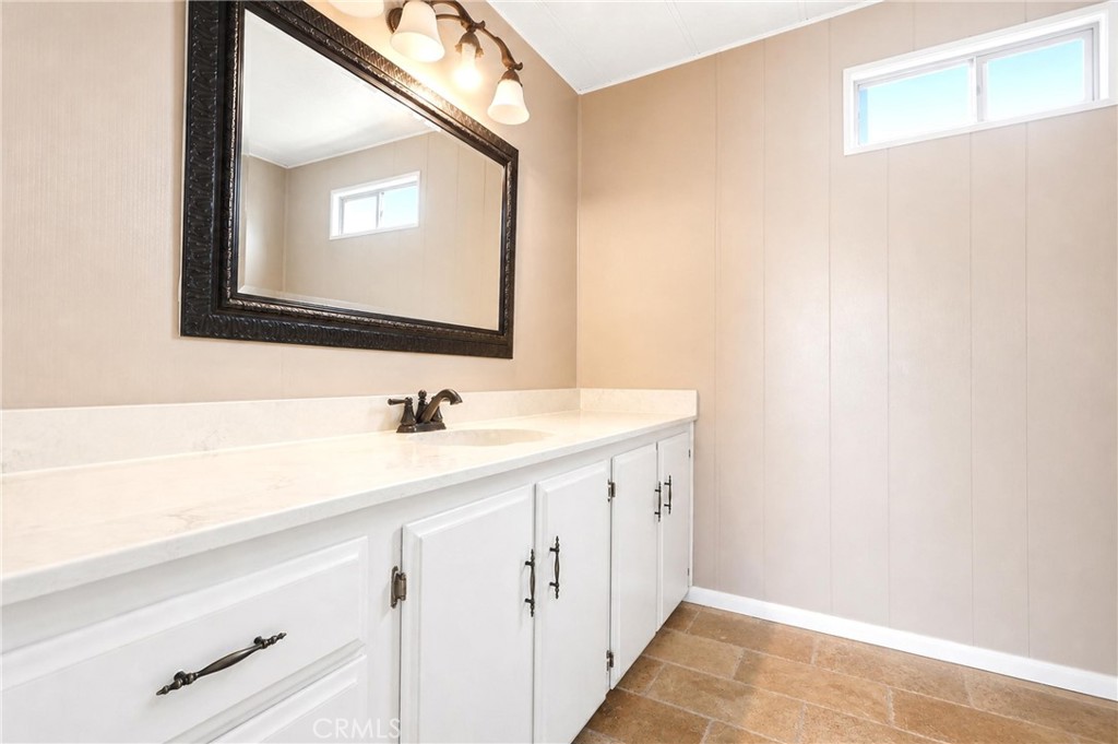 9391 California Avenue, Unit 35 Riverside, CA 92503 - Photo 15 of 32 a bathroom with a sink a vanity and a mirror