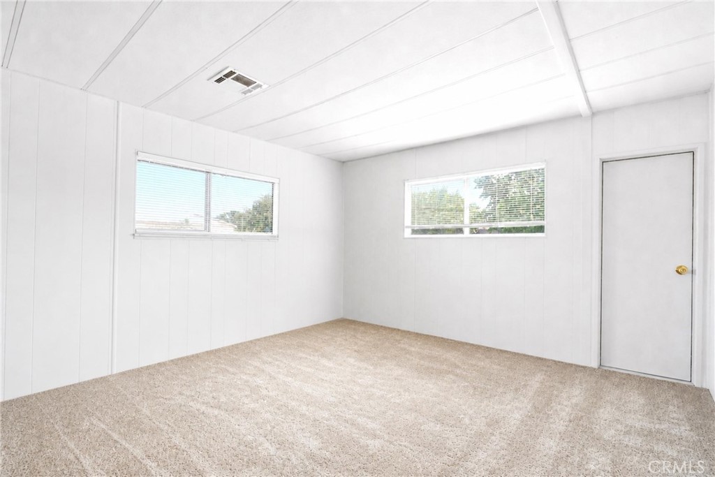 9391 California Avenue, Unit 35 Riverside, CA 92503 - Photo 19 of 32 an empty room with windows