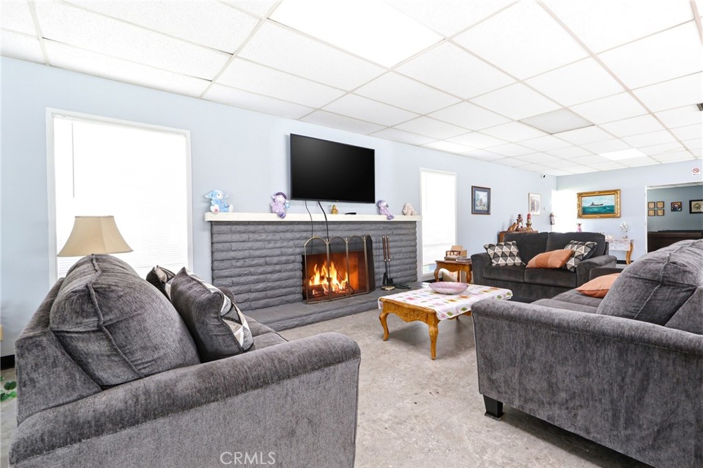9391 California Avenue, Unit 35 Riverside, CA 92503 - Photo 27 of 32 a living room with furniture a flat screen tv and a fireplace